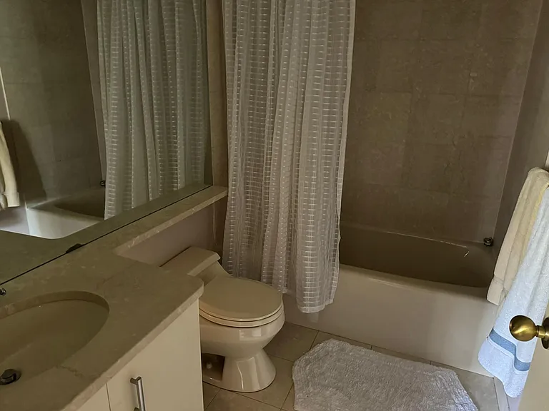 Full bathroom with clean vanity storage and full tub/shower setup.