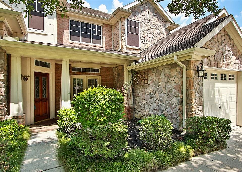 A welcoming covered front entry to this pretty home. Stone accents and lovely landscaping add a nice touch.