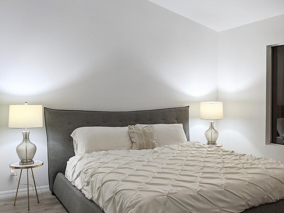 Master Bedroom Furnished with Cal King Bed. Private attached bathroom renovated with real white carrara marble countertops and mosaic tile shower