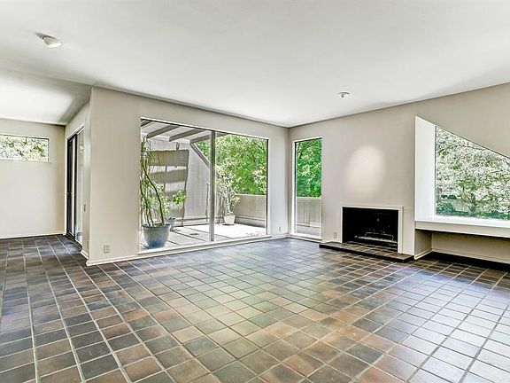 View of large balcony from the living room. Spot light over Fireplace for your favorite art piece.