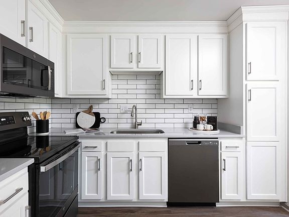 Modern kitchen with slate appliances and white cabinetry