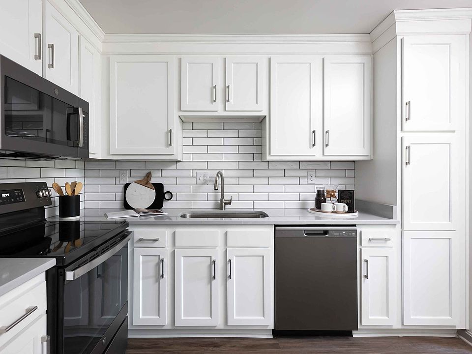 Modern kitchen with slate appliances and white cabinetry