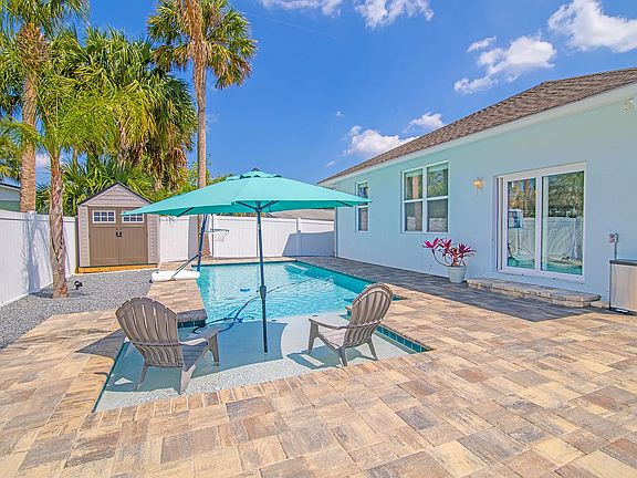 Outdoor patio by the pool. Storage shed for bicycles or pool toys.