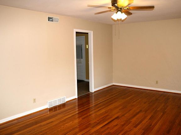 Large family room with beautiful hardwood floors.