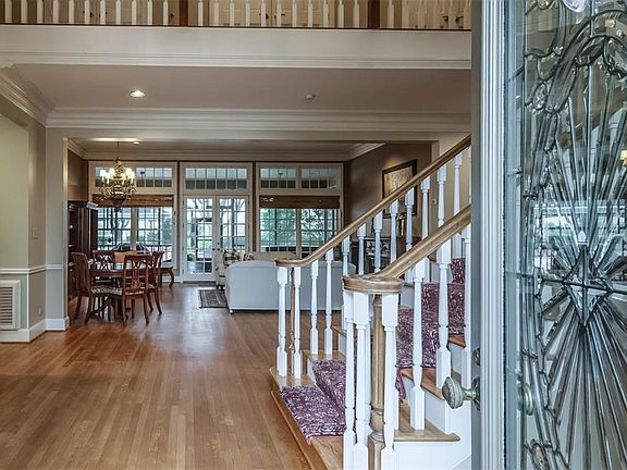 Leaded glass door opens to rustic tongue and groove hard woods and a direct view to the backyard