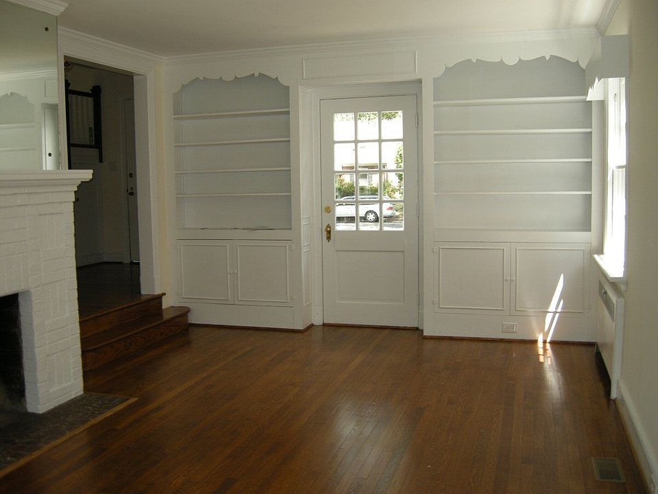 Fireplace and built in bookcases off foyer