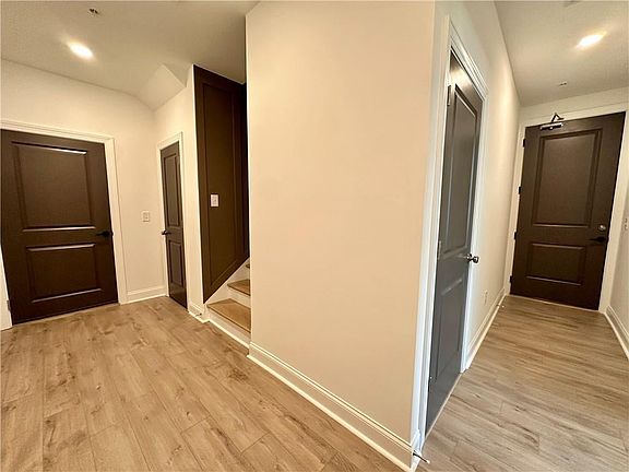 Guest enter front door on the right and garage access to the left Photo from decorated model. Same