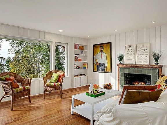 Painted real-wood panelling and hardwood floors make it easy to cozy up to the wood burning fireplac