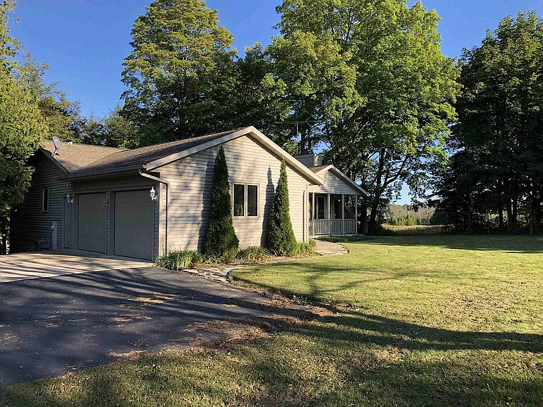 Exterior view, house surrounded by woods and fields, not visible from highway 57 providing safety and privacy.