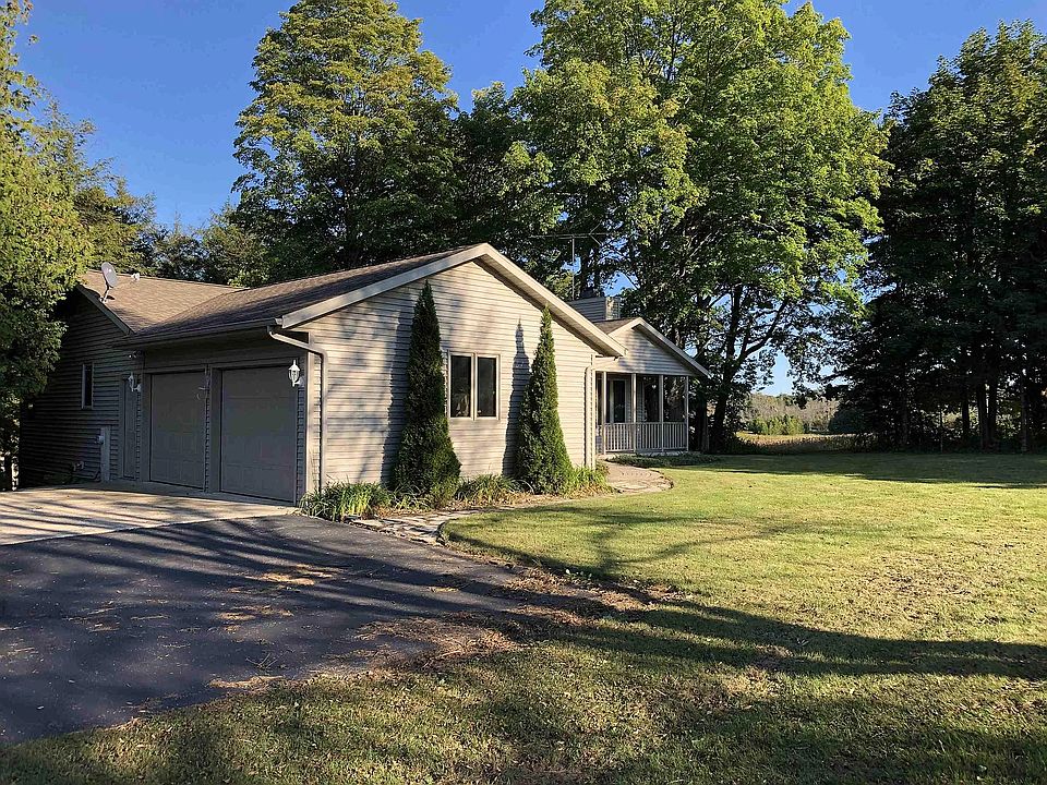 Exterior view, house surrounded by woods and fields, not visible from highway 57 providing safety and privacy.