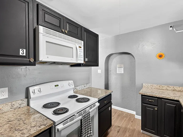 Kitchen with an Oven, Stove-Top, Microwave and Cabinets assigned to Each Member