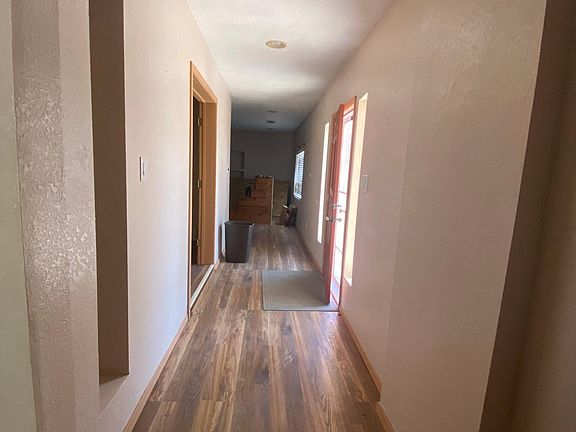 Entry way. Hallway to the right leads to large family room. Hallway to the left leads to bedrooms and second living area. Directly in front of entry door is the study/office.