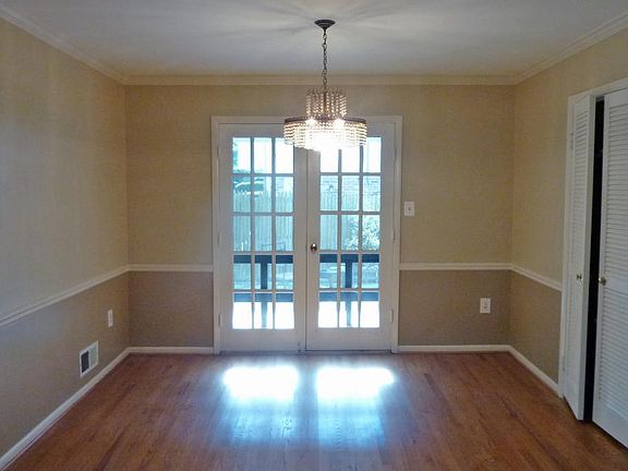 Large dining room with French doors open to covered porch
