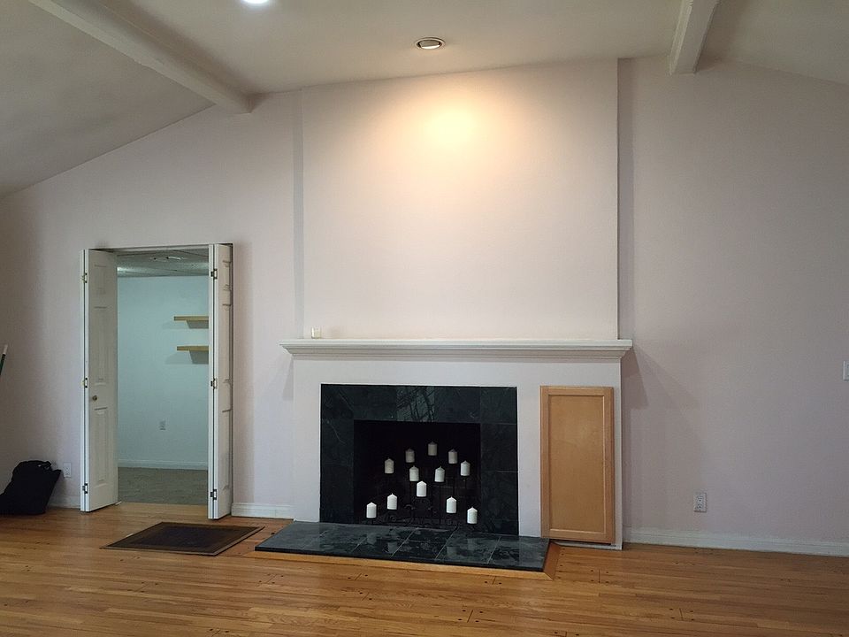Living room with vaulted ceiling and peg and groove floors.