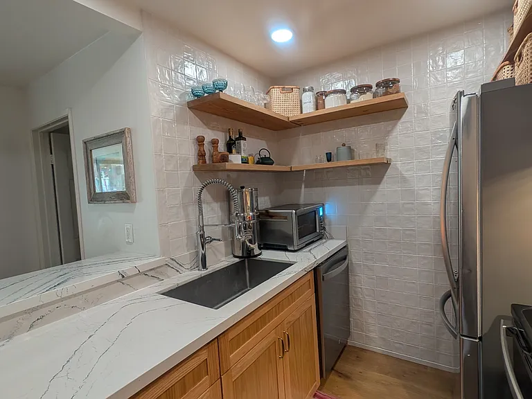 Fully remodeled kitchen includes, deep stainless steel sink, large fridge, dishwasher, electric stove, new countertops and cabinets