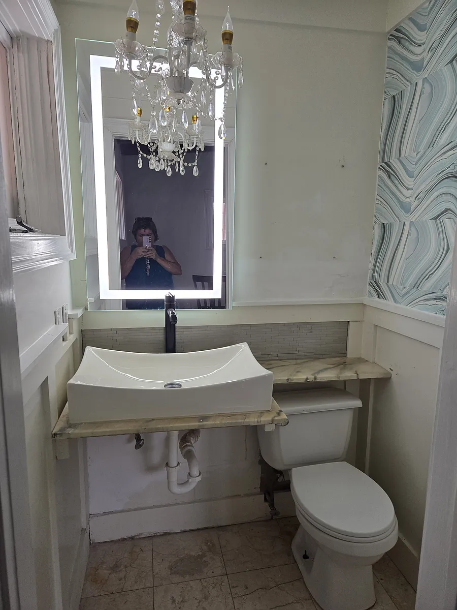 Customized half bath, makeup lights built into the mirror. Large sink and beautiful chandelier. Marble floor - 2614 Juniper Ave