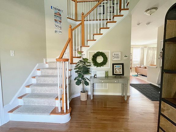 Entry. Living room and Dining Room on the left. Family Room, Kitchen, Breakfast nook straight ahead. Garage, coat closets, and bathroom on the right.