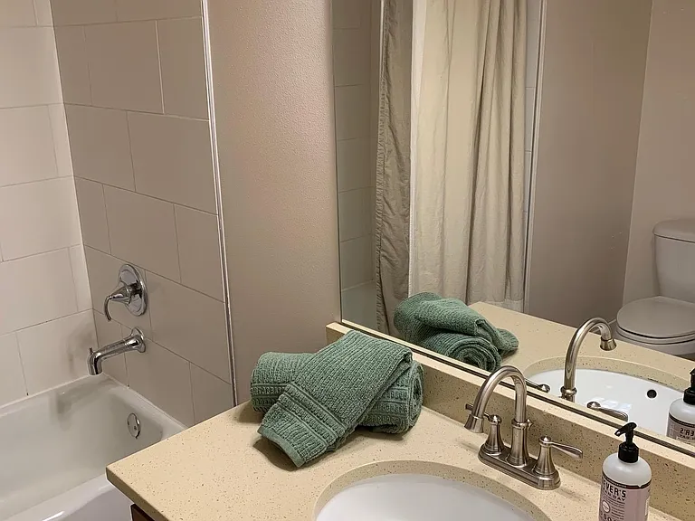 Full size bathroom with bathtub/shower combo.