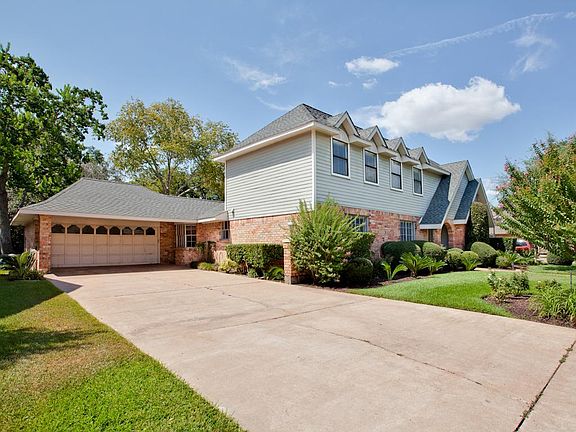  Front view of the home with two car garage and porte-cochère.