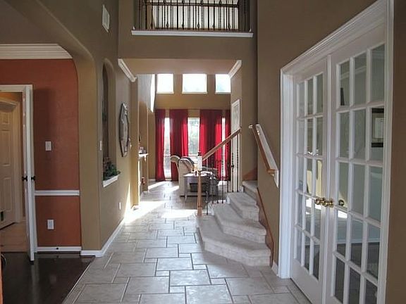 Upon entrance you have a study/library to the right with wood floors, french doors and built-ins. To your left is the gorgeous Venitian painted formal dining room with wood floors and custom light fixture.