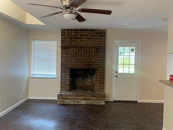 Living room with skylight and nonfunctional fireplace (decorative use only).