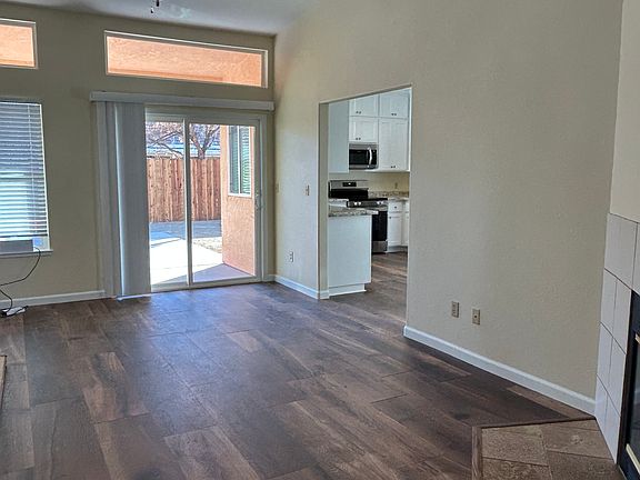 Sliding glass door from den leads to covered patio and fenced backyard.