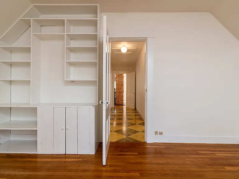 built-in and view down hallway to kit