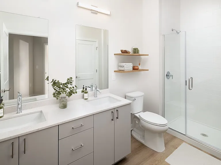 Base Collection bath with white quartz countertop, grey cabinetry, and hard surface flooring