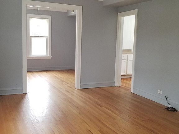 Spacious living room with 3 large windows.