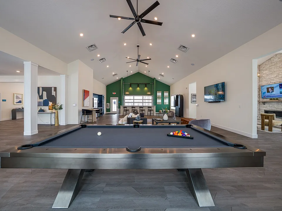 Step into leisure at VC Park Apartments, where the vibrant community lounge features a billiards table and spacious seating. Perfect for gatherings and relaxation, this inviting space blends comfort and style. Schedule a tour today!
