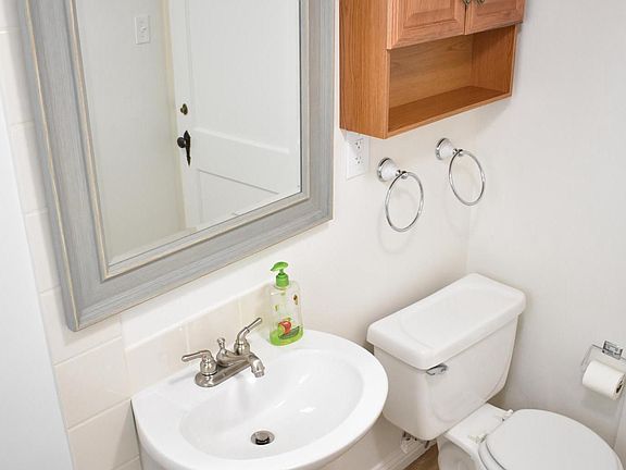 New toilet, medicine cabinet, mirror, pedestal sink, hardwoo