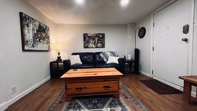 Spacious living room faces smart tv for your streaming binge watching pleasure.
