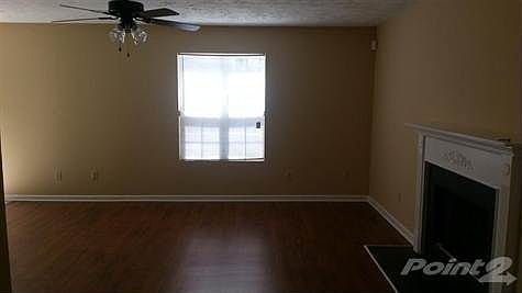 Family room with new ceiling fan, flooring, and paint.