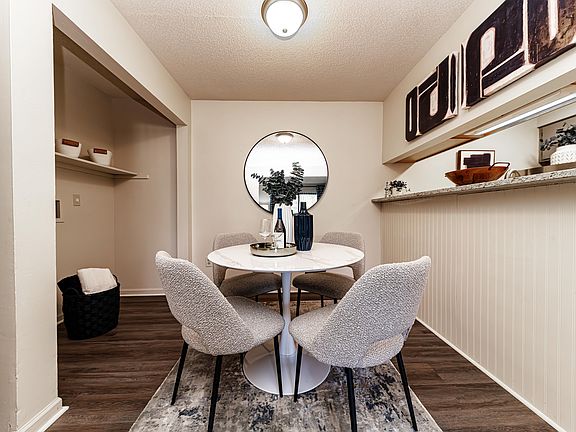 Dining area with hardwood-style flooring and overhead lighting