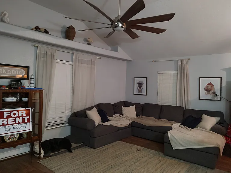 Living area large enough for a sectional sofa. Decorative ledge/shelf above. Remote control ceiling fan with multiple speeds and overhead light capability.