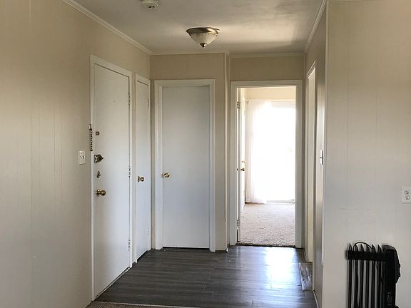 Living room reverse view to bedroom and entrance way