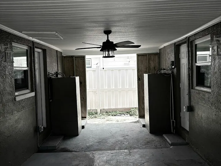 Nice area in breezeway even has ceiling fan for added comfort.
