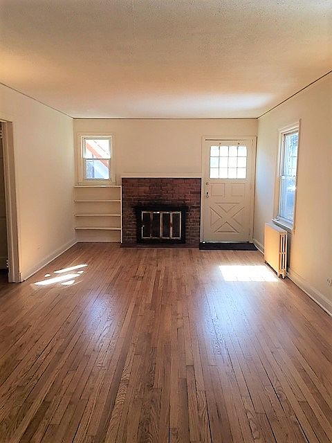 Large living room with fireplace and built in bookshelf