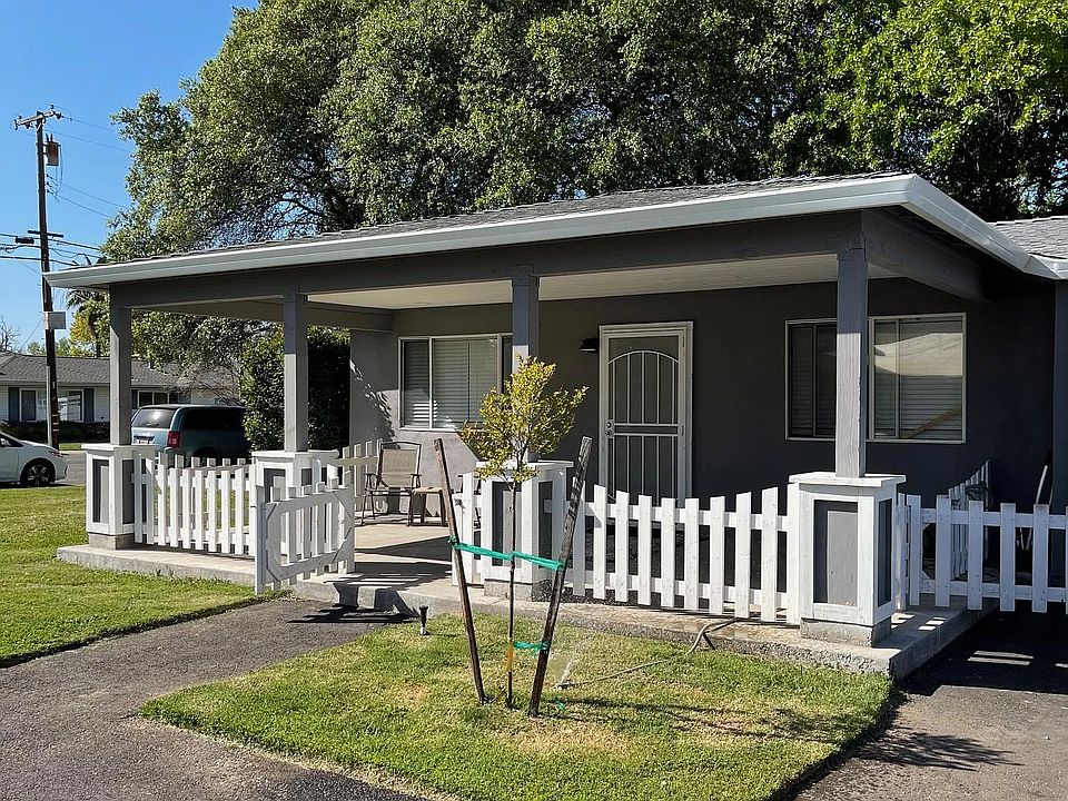 Front of home with gated covered patio