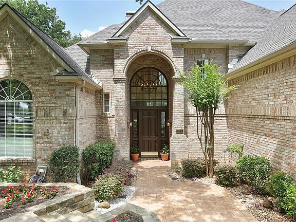 WOW... WHAT AN ENTRANCE!  THE FRESHLY PAINTED FRONT DOOR AND LARGE ARCHED WINDOW ABOVE OFFER AN ELEGANT LOOK