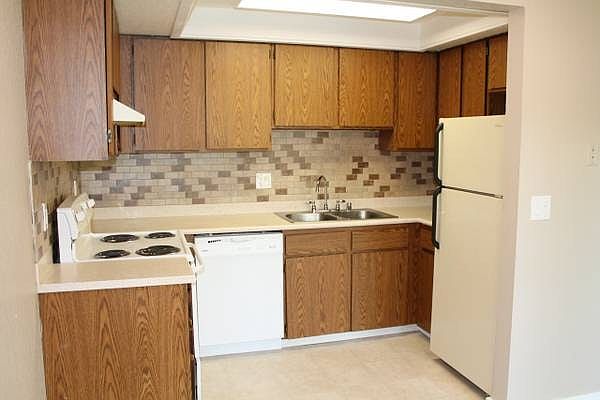 Kitchen with Tile Backsplash & Solid Surface Countertops