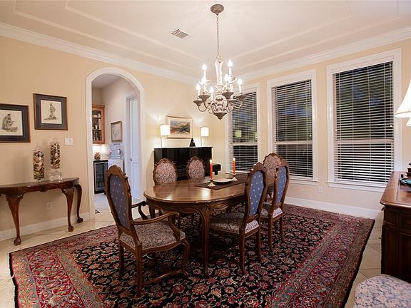 The dining room, with trayed ceilings and crown molding accents, and spacious enough for a large group.