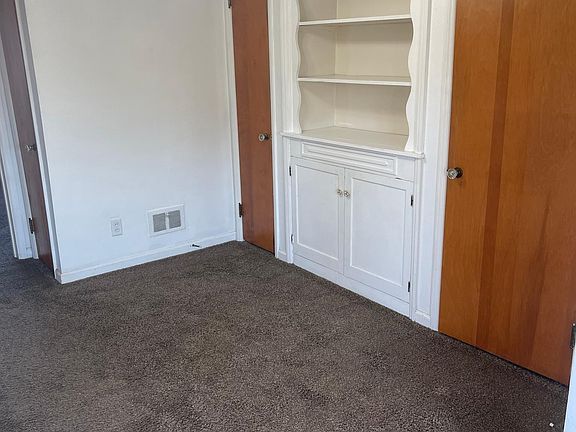 Dining room with book shelf or trophy shelf and two closets.