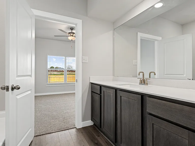 The master bathroom has a sprawling vanity.