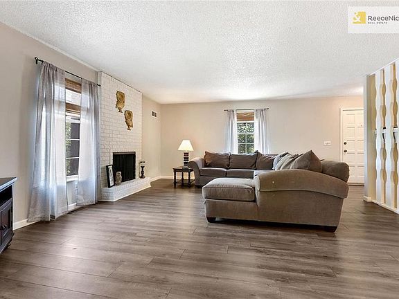 Huge main level living room provides tons of light, neutral paint colors, and a fireplace