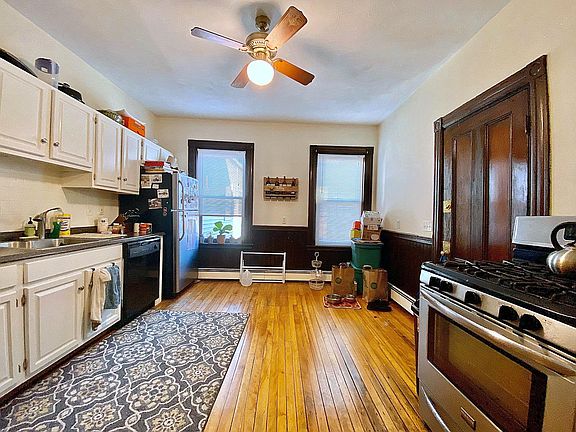 Full Kitchen. Can fit a table and chairs by the window. Back door goes directly down to laundry, storage and shared common patio's with grills