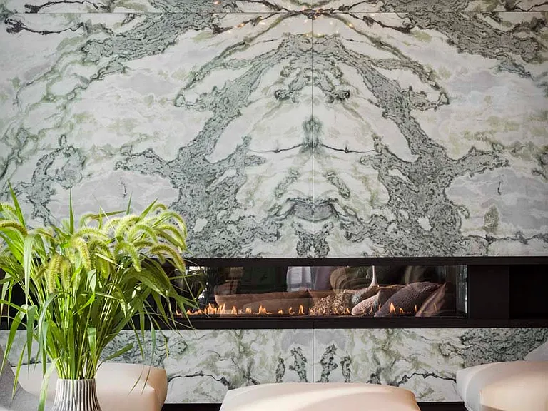 Step into comfort and sophistication by the lounge's marble fireplace