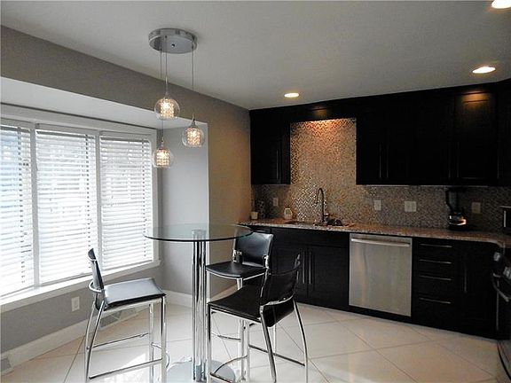 Large bay window in the lovely remodeled eat-in kitchen.