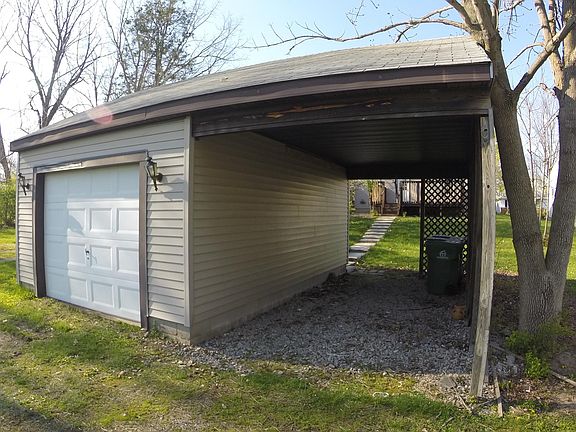 Driveway leads to back of the house where there is a garage and carport...covered space for 2 vehicles!
