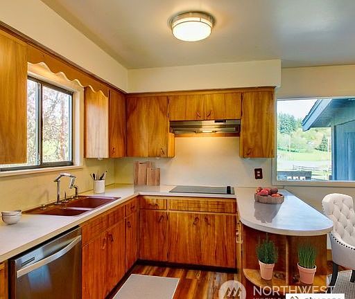Staged kitchen with wood cabinets>